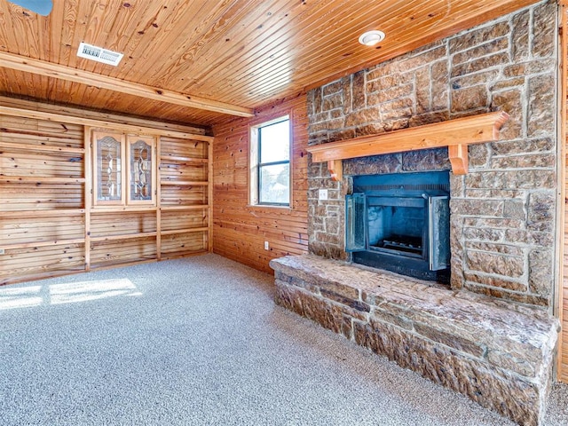3402 Oakhurst Dr, Oklahoma City, OK 73110 - unfurnished living room with carpet, wooden walls, visible vents, wood ceiling, and a fireplace