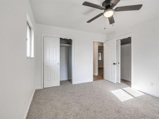 3402 Oakhurst Dr, Oklahoma City, OK 73110 - unfurnished bedroom with two closets, carpet floors, a ceiling fan, and baseboards