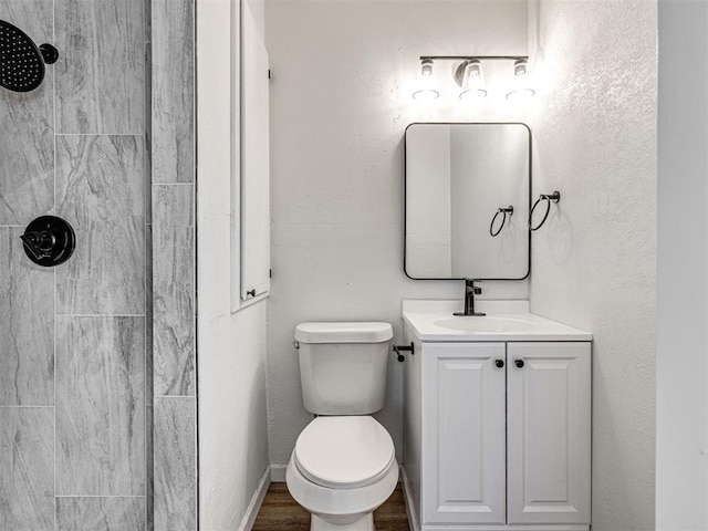 3402 Oakhurst Dr, Oklahoma City, OK 73110 - full bathroom with wood finished floors, toilet, vanity, baseboards, and tiled shower