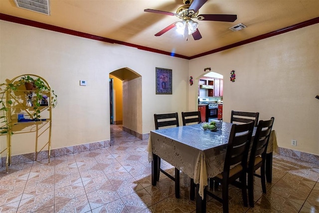 dining area featuring arched walkways, visible vents, ornamental molding, and ceiling fan