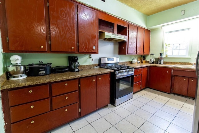 kitchen featuring under cabinet range hood, open shelves, light tile patterned flooring, gas stove, and a textured ceiling