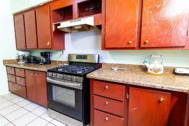 kitchen with light countertops, stainless steel range with gas stovetop, under cabinet range hood, and light tile patterned floors