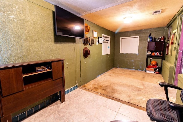 hallway with tile patterned flooring and visible vents