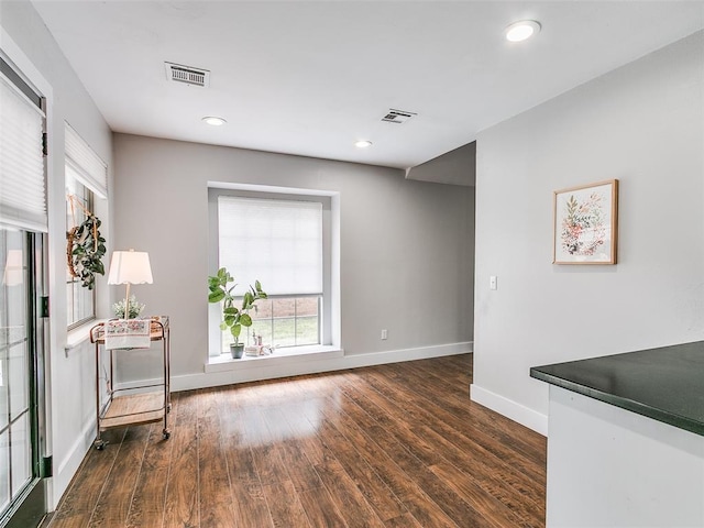 interior space featuring dark wood-type flooring, visible vents, recessed lighting, and baseboards