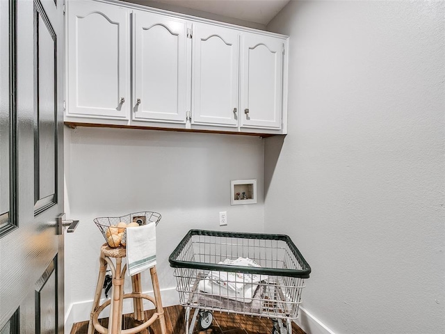 interior space featuring baseboards and washer hookup