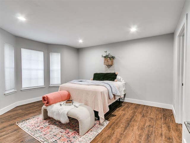 bedroom featuring wood finished floors, recessed lighting, and baseboards