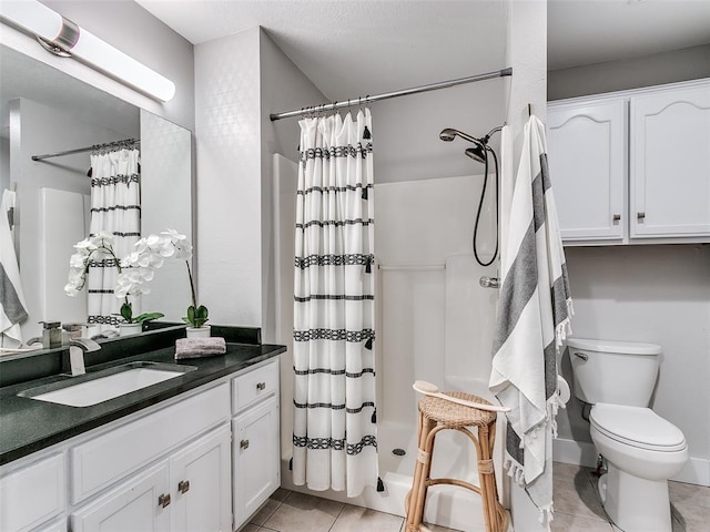 bathroom with a shower with curtain, vanity, toilet, and tile patterned floors