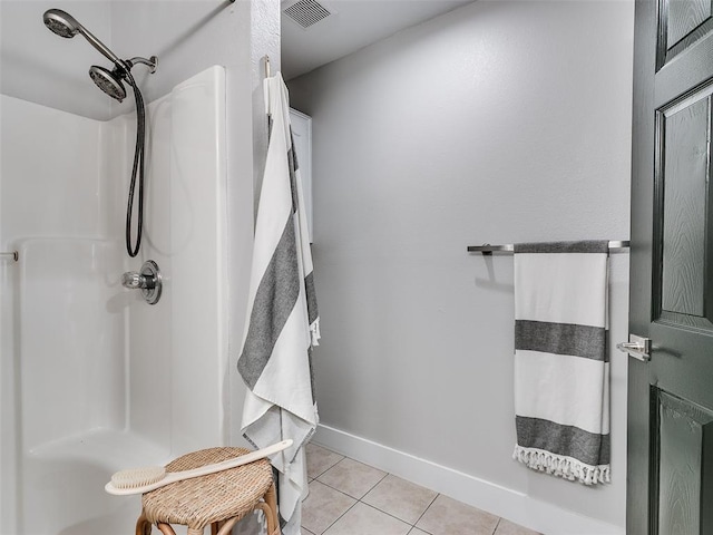 bathroom with tile patterned floors, visible vents, walk in shower, and baseboards