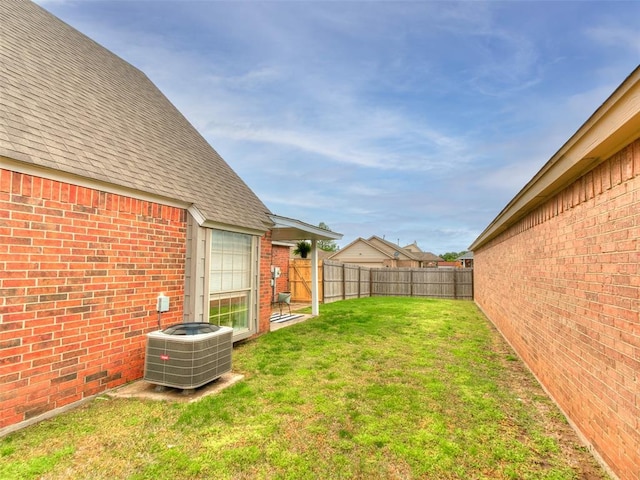 view of yard with a fenced backyard and cooling unit