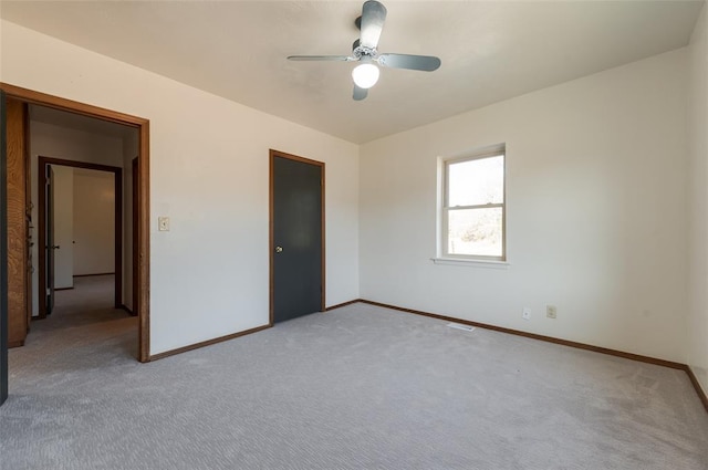 unfurnished bedroom with visible vents, a ceiling fan, baseboards, and light carpet