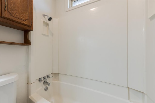 bathroom with shower / bathing tub combination and toilet