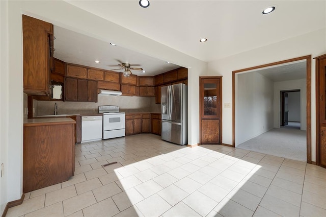 kitchen featuring exhaust hood, light tile patterned floors, white appliances, and recessed lighting