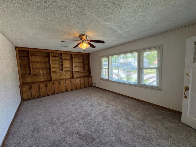 608 Roosevelt St, Seminole, OK 74868 - carpeted spare room with baseboards, visible vents, a textured ceiling, and ceiling fan