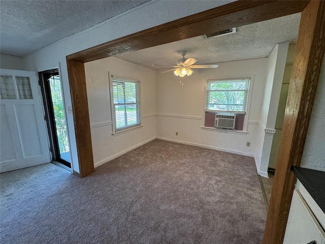 608 Roosevelt St, Seminole, OK 74868 - empty room featuring visible vents, cooling unit, a textured ceiling, carpet flooring, and ceiling fan