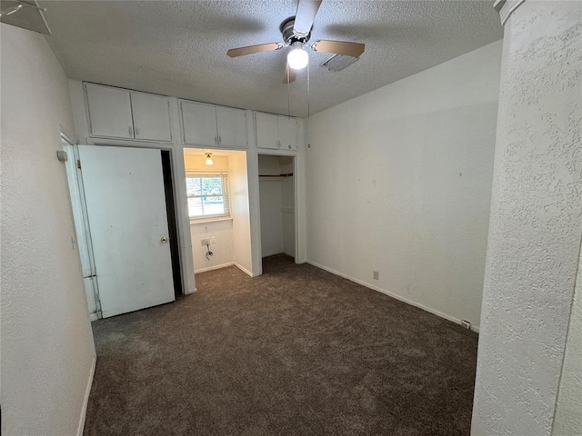 608 Roosevelt St, Seminole, OK 74868 - unfurnished bedroom with dark carpet, a textured wall, a textured ceiling, and freestanding refrigerator