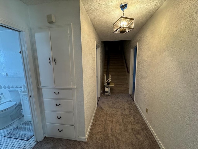 608 Roosevelt St, Seminole, OK 74868 - corridor featuring a textured wall, a textured ceiling, carpet flooring, and stairs