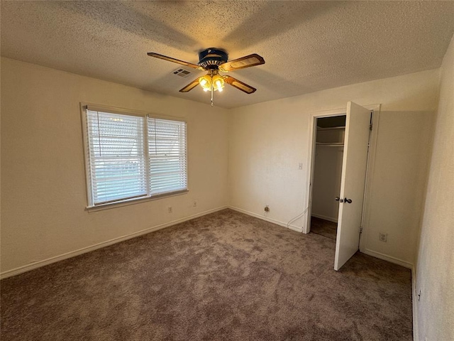 608 Roosevelt St, Seminole, OK 74868 - unfurnished bedroom with carpet, a spacious closet, visible vents, baseboards, and a textured ceiling