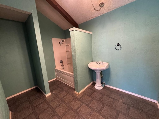 608 Roosevelt St, Seminole, OK 74868 - bathroom featuring vaulted ceiling, bathtub / shower combination, and a textured ceiling