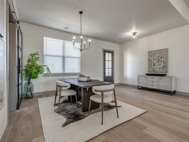 1529 Pedras Pl, Newcastle, OK 73065 - dining space featuring a chandelier, light wood-style flooring, and baseboards