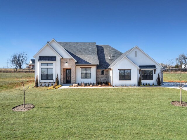 1529 Pedras Pl, Newcastle, OK 73065 - modern inspired farmhouse featuring a front yard and a standing seam roof