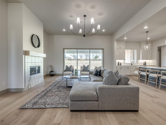 1529 Pedras Pl, Newcastle, OK 73065 - living area with recessed lighting, a chandelier, a fireplace, light wood-style floors, and baseboards