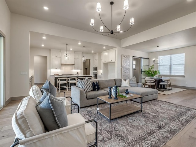 1529 Pedras Pl, Newcastle, OK 73065 - living area with a chandelier, light wood-style floors, baseboards, a barn door, and recessed lighting