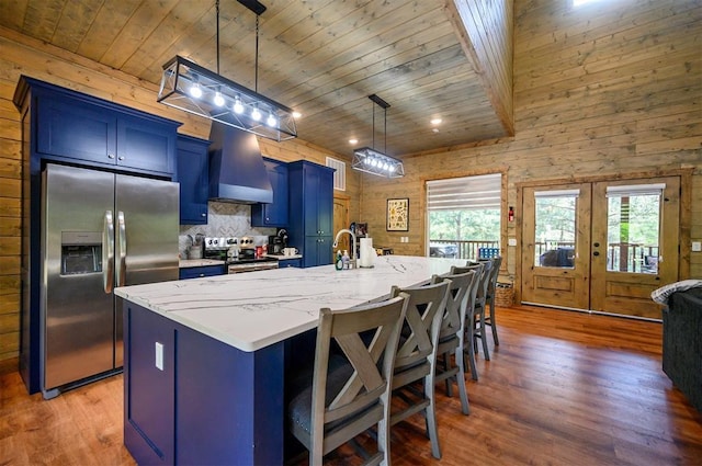 66 Morning Pines Trl, Broken Bow, OK 74728 - kitchen with exhaust hood, blue cabinets, wood finished floors, wooden ceiling, and stainless steel appliances