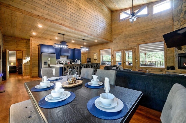 66 Morning Pines Trl, Broken Bow, OK 74728 - dining space with wooden walls, a high ceiling, a ceiling fan, wooden ceiling, and wood finished floors