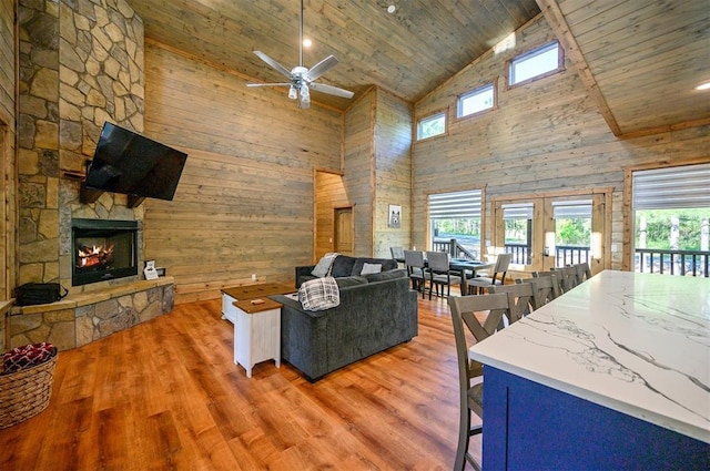 66 Morning Pines Trl, Broken Bow, OK 74728 - living area featuring a healthy amount of sunlight, high vaulted ceiling, and a stone fireplace