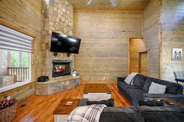 66 Morning Pines Trl, Broken Bow, OK 74728 - living area featuring visible vents, wood walls, wood finished floors, a fireplace, and wooden ceiling