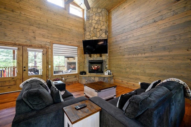 66 Morning Pines Trl, Broken Bow, OK 74728 - living area with high vaulted ceiling, wood walls, a wealth of natural light, and wood ceiling