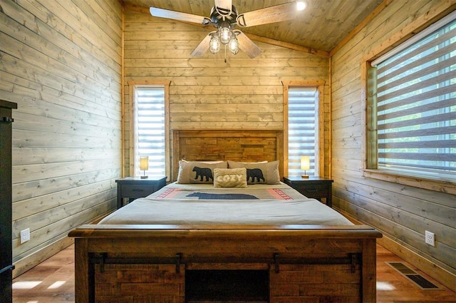 66 Morning Pines Trl, Broken Bow, OK 74728 - bedroom featuring multiple windows, wood walls, wood finished floors, lofted ceiling, and visible vents