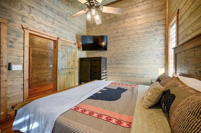66 Morning Pines Trl, Broken Bow, OK 74728 - bedroom featuring a ceiling fan and wood walls