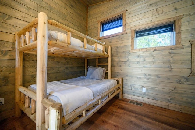 66 Morning Pines Trl, Broken Bow, OK 74728 - bedroom featuring wooden walls, visible vents, and wood finished floors