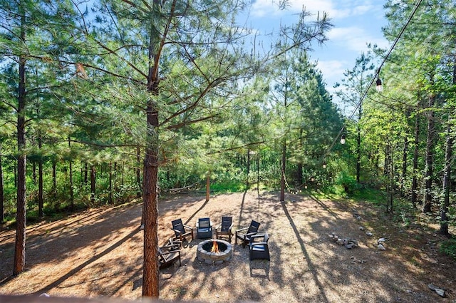 66 Morning Pines Trl, Broken Bow, OK 74728 - view of yard with a wooded view and a fire pit