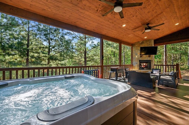 66 Morning Pines Trl, Broken Bow, OK 74728 - deck featuring an outdoor stone fireplace, ceiling fan, and a hot tub