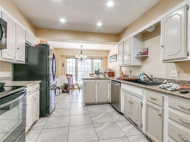 12141 Greenlawn Ave, Oklahoma City, OK 73170 - kitchen with a sink, black electric range, dishwasher, an inviting chandelier, and a peninsula