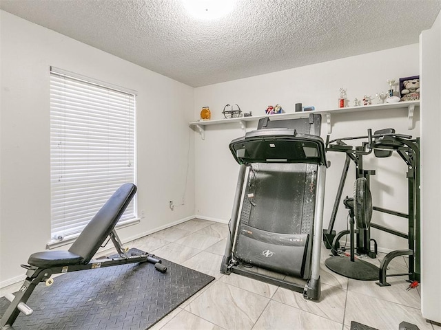 12141 Greenlawn Ave, Oklahoma City, OK 73170 - exercise room featuring baseboards and a textured ceiling