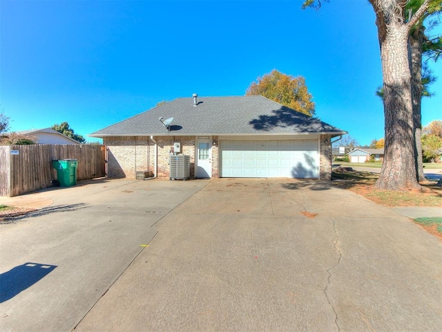 12141 Greenlawn Ave, Oklahoma City, OK 73170 - view of front of home with concrete driveway, an attached garage, fence, and roof with shingles