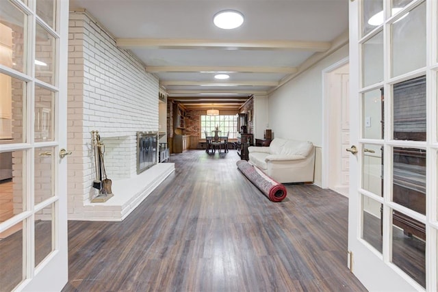 corridor with brick wall, beamed ceiling, baseboards, french doors, and dark wood-type flooring