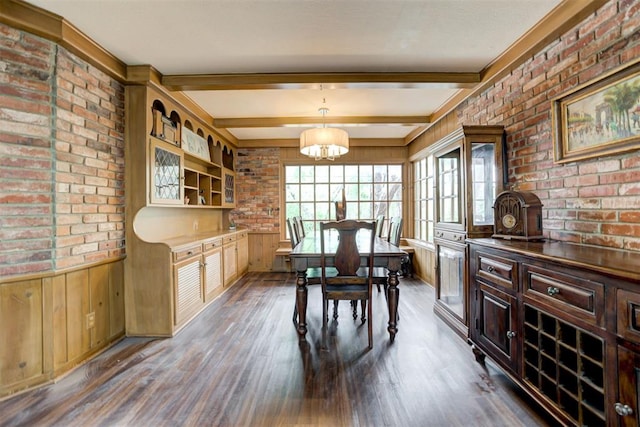 dining room with dark wood-style flooring, brick wall, and beamed ceiling
