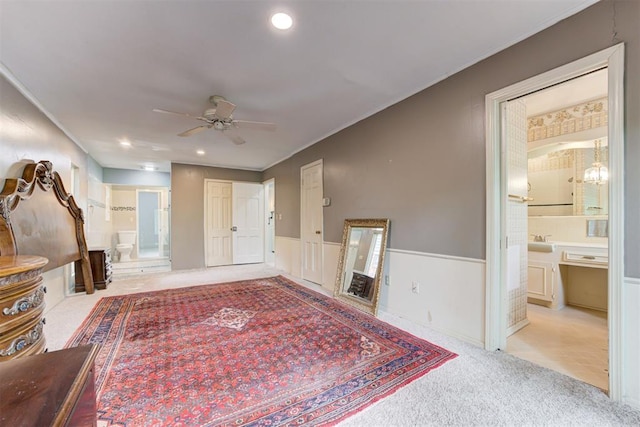 unfurnished living room featuring recessed lighting, carpet floors, ceiling fan, a sink, and crown molding