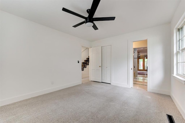 unfurnished bedroom with carpet, ensuite bath, and baseboards
