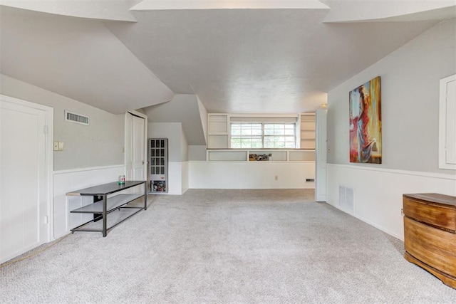 interior space with visible vents, wainscoting, and carpet floors