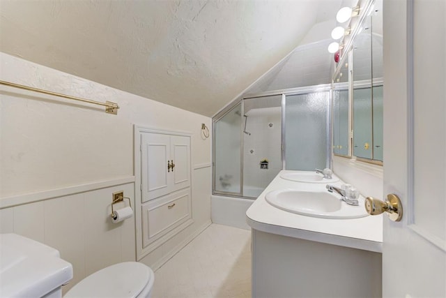 full bath with combined bath / shower with glass door, toilet, lofted ceiling, and a sink