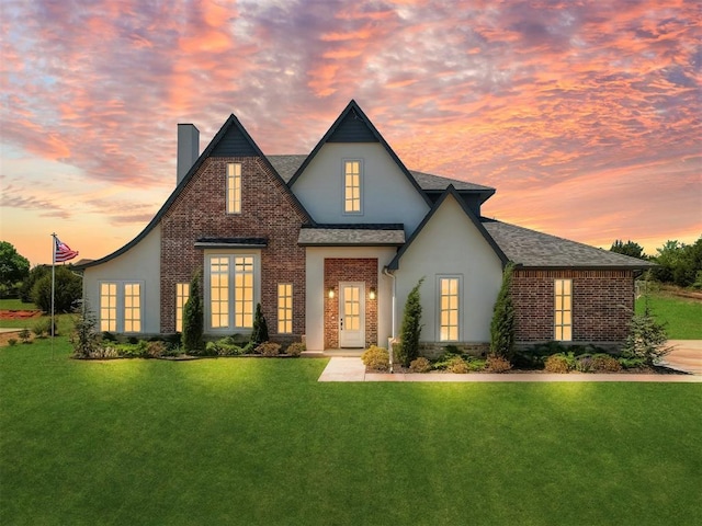 3261 Red Ridge Dr, Blanchard, OK 73010 - view of front facade with a front lawn, brick siding, stucco siding, and a chimney
