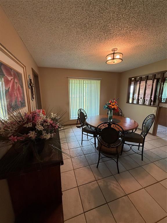 4108 N Broadway Ave, Hinton, OK 73047 - dining room featuring light tile patterned flooring and a textured ceiling