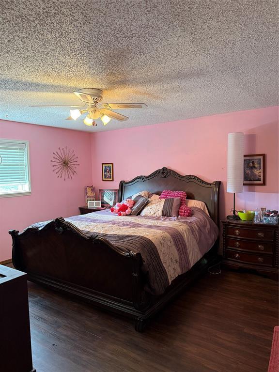 4108 N Broadway Ave, Hinton, OK 73047 - bedroom featuring a textured ceiling, a ceiling fan, and wood finished floors