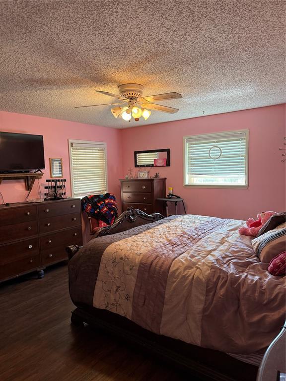 4108 N Broadway Ave, Hinton, OK 73047 - bedroom with a textured ceiling, wood finished floors, and ceiling fan
