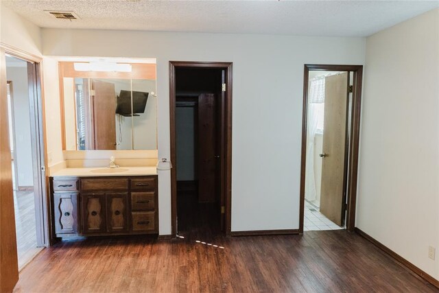 4108 N Broadway Ave, Hinton, OK 73047 - bathroom with wood finished floors, vanity, visible vents, and baseboards